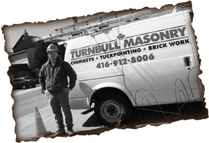 Turnbull Masonry truck with Clint Turnbull standing in front of it.