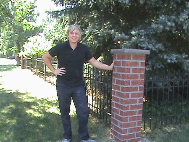 Clint Turnbull standing next to brick post.
