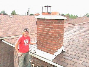 Clint Turnbull in front of repaired chimney.