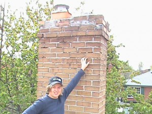 Clint Turnbull standing in front of crumbling chimney.