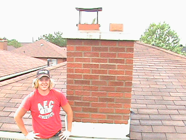 Clint Turnbull in front of repaired chimney in Toronto.