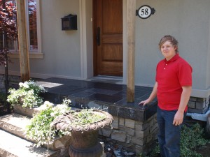 Clint Turnbull in front of newly built front porch.