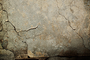 Cracked concrete wall in need of repair.