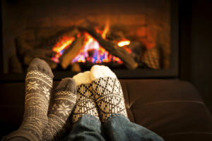 family sitting in front of fireplace