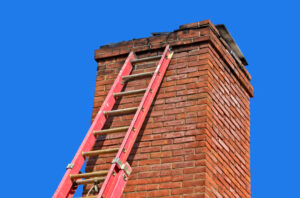 Old chimney being repaired by mason