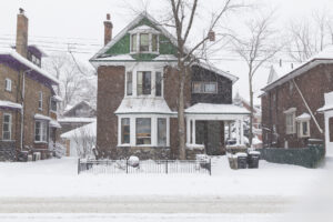 A house in Toronto during a snow storm, showing lots of snow outside the building