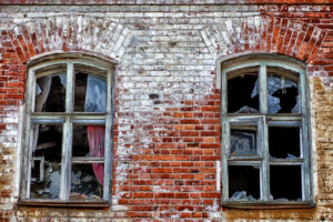 19th century brick building with broken windows. 